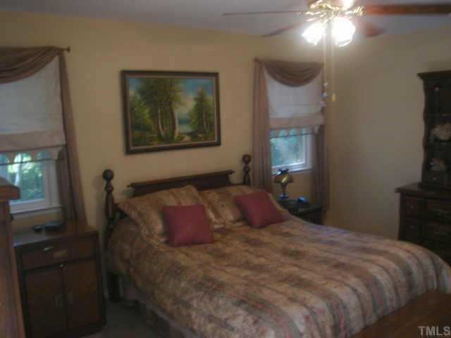 206 Dartmouth Road Raleigh, NC 27609 - Photo 7 of 9 a bedroom with a bed and a flat tv screen on dresser