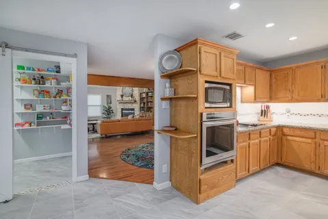 a kitchen with stainless steel appliances granite countertop a stove a sink and a refrigerator