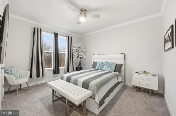 a spacious bedroom with a bed and a flat screen tv