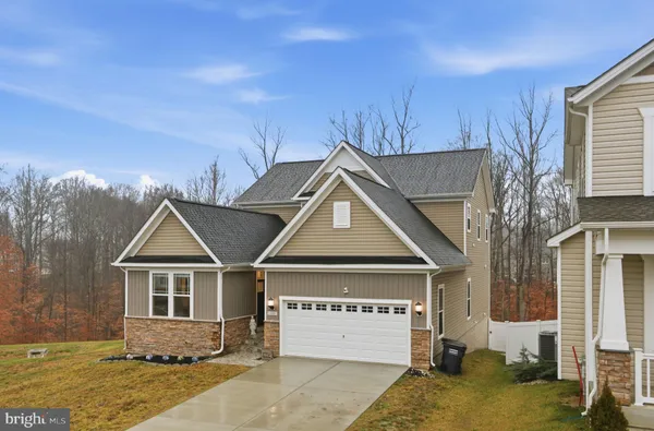 an front view of a house with a yard
