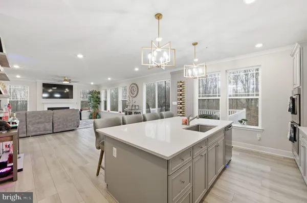 a living room with furniture or chandelier and a dining table