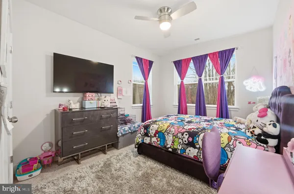 a view of staircase with railing and white walls