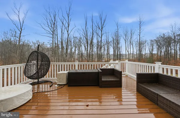 a view of a roof deck with wooden floor and fence