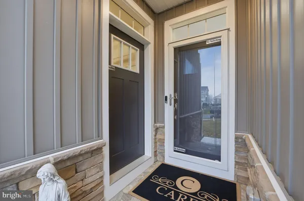 a view of a hallway with wooden floor and entryway