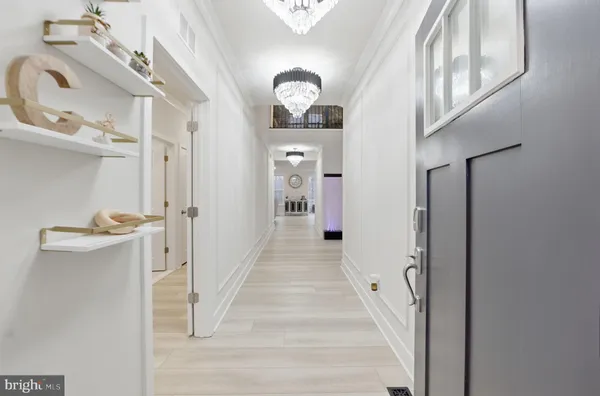 a view of entryway and hall with wooden floor