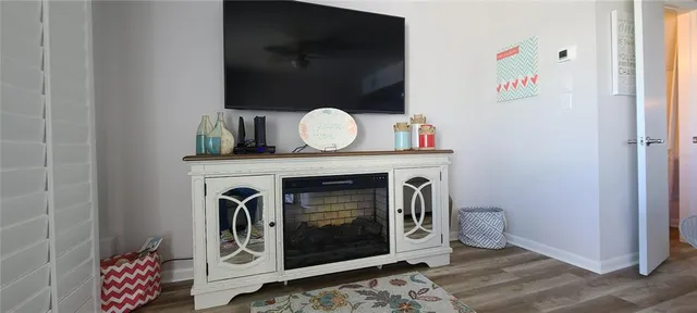 a hallway with a fireplace and wooden floor