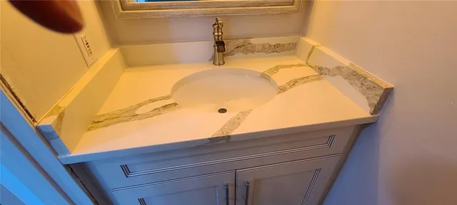 a bathroom with a sink and mirror