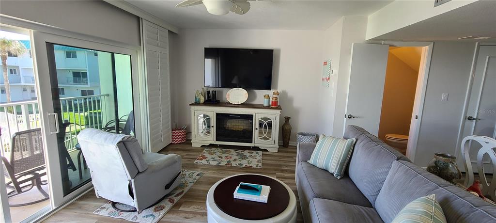 815 Ocean Shore Boulevard, Unit 7B Ormond Beach, FL 32176 - Photo 19 of 19 a living room with furniture and a fireplace