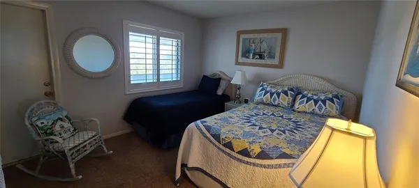 a bedroom with a bed chair and a window