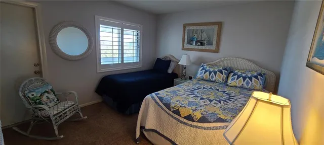 a bedroom with a bed chair and a window