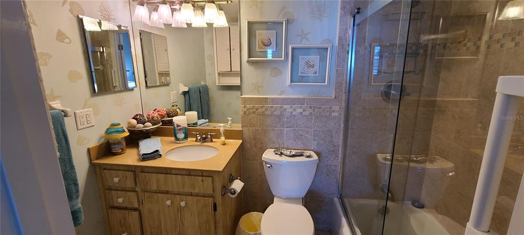 815 Ocean Shore Boulevard, Unit 7B Ormond Beach, FL 32176 - Photo 7 of 19 a bathroom with a sink toilet and shower