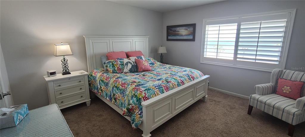 815 Ocean Shore Boulevard, Unit 7B Ormond Beach, FL 32176 - Photo 8 of 19 a bedroom with a bed and a window