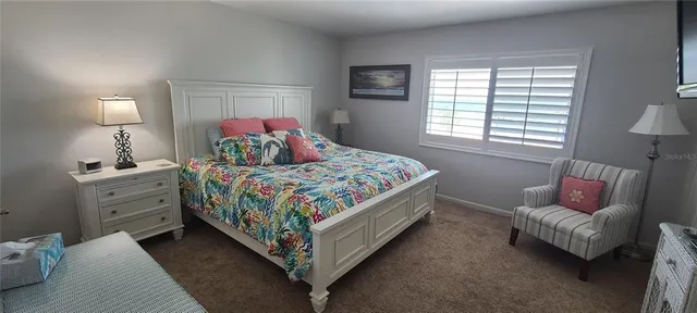 a bedroom with a bed couch and a window
