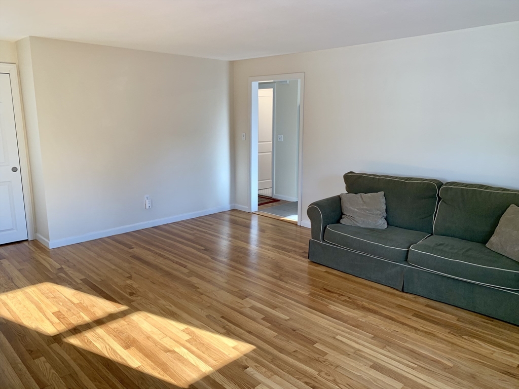 18 Guernsey Street, Unit 2 Marblehead, MA 01945 - Photo 12 of 23 a view of livingroom with furniture and wooden floor