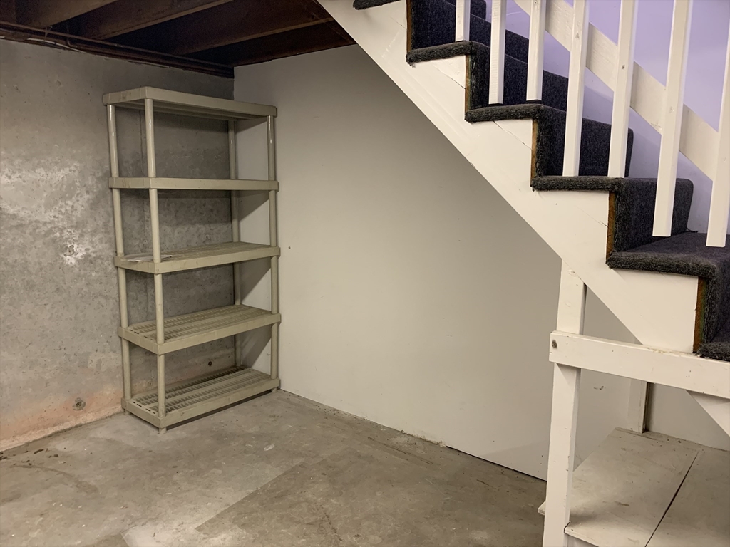 18 Guernsey Street, Unit 2 Marblehead, MA 01945 - Photo 22 of 23 a view of staircase with white walls and a window