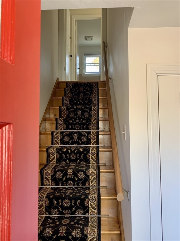 18 Guernsey Street, Unit 2 Marblehead, MA 01945 - Photo 4 of 23 a view of a hallway with wooden floor and windows