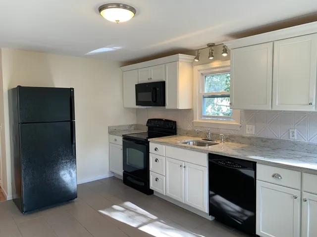 a kitchen with a refrigerator and a sink