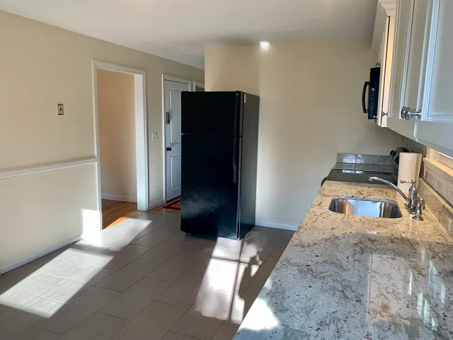 a kitchen with stainless steel appliances granite countertop a refrigerator and a sink
