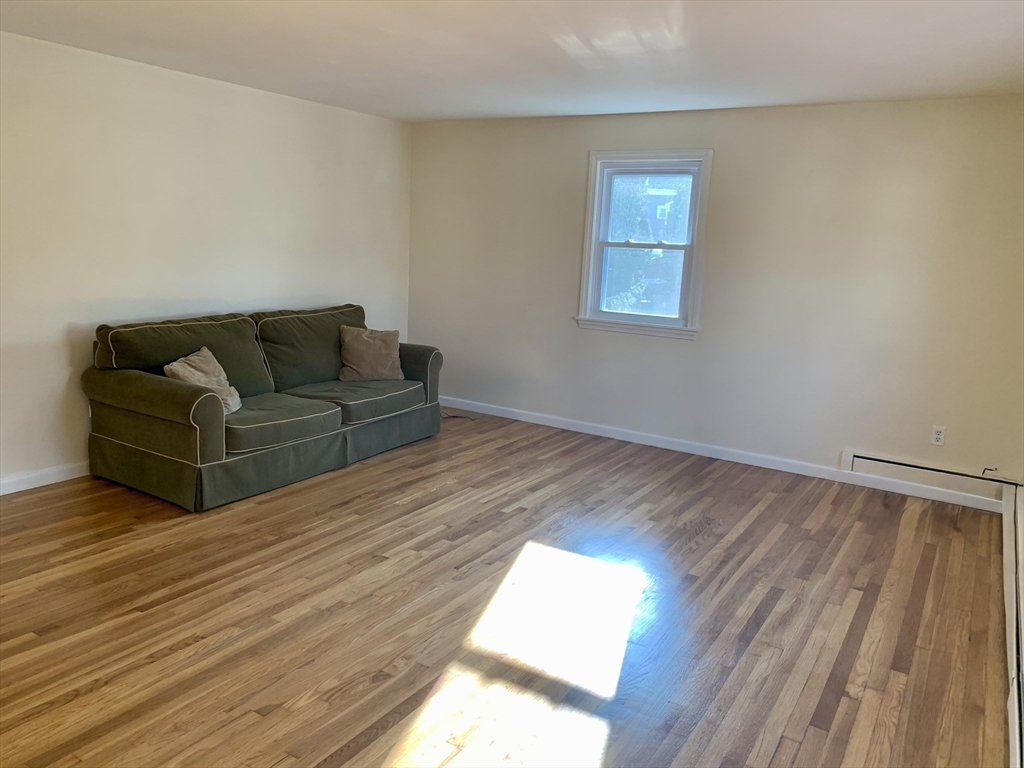 18 Guernsey Street, Unit 2 Marblehead, MA 01945 - Photo 10 of 23 a living room with furniture and a wooden floor