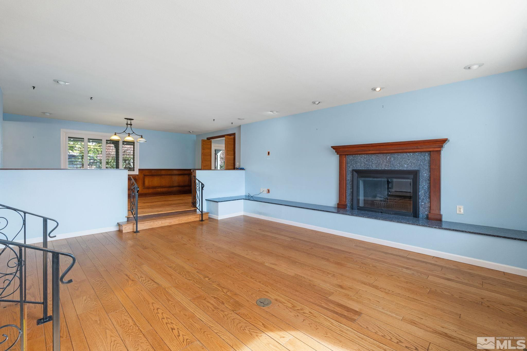 3325 Norman Drive Reno, NV 89509 - Photo 12 of 40 a view of an empty room with wooden floor and a fireplace