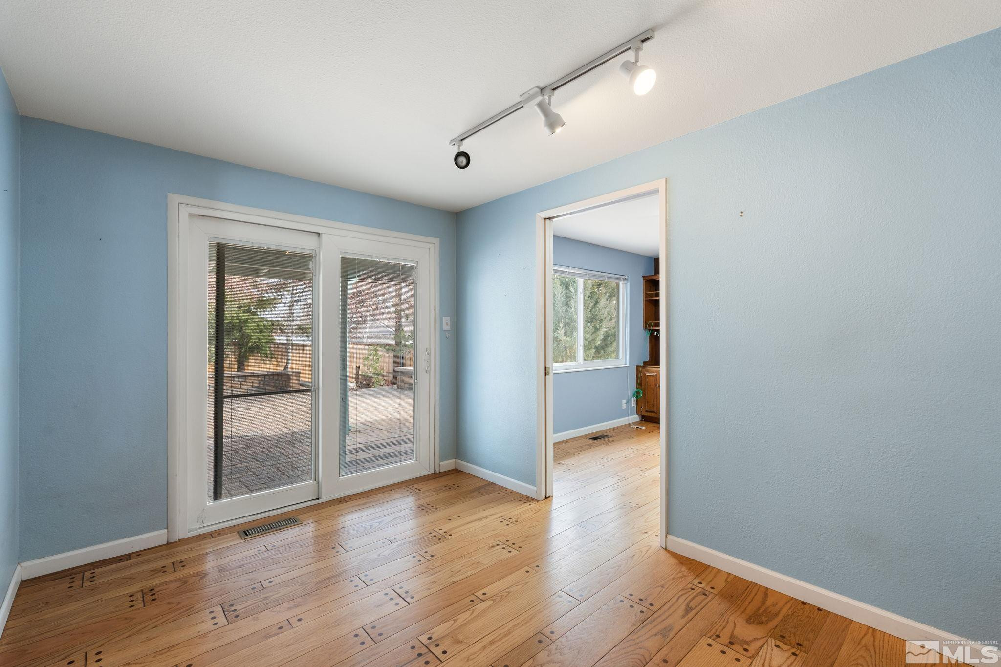 3325 Norman Drive Reno, NV 89509 - Photo 18 of 40 an empty room with wooden floor and windows