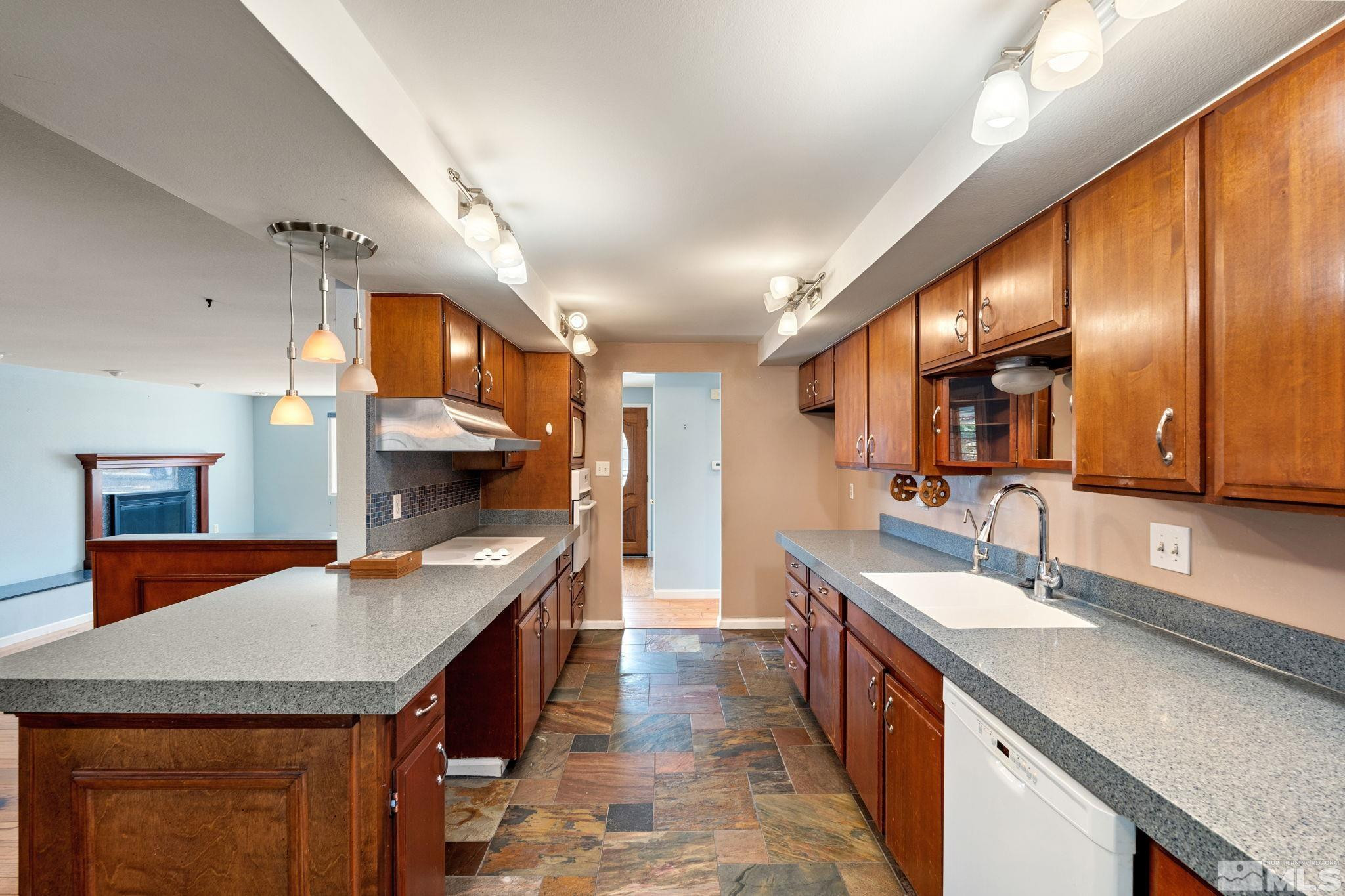 3325 Norman Drive Reno, NV 89509 - Photo 22 of 40 a kitchen with stainless steel appliances granite countertop a sink and stove