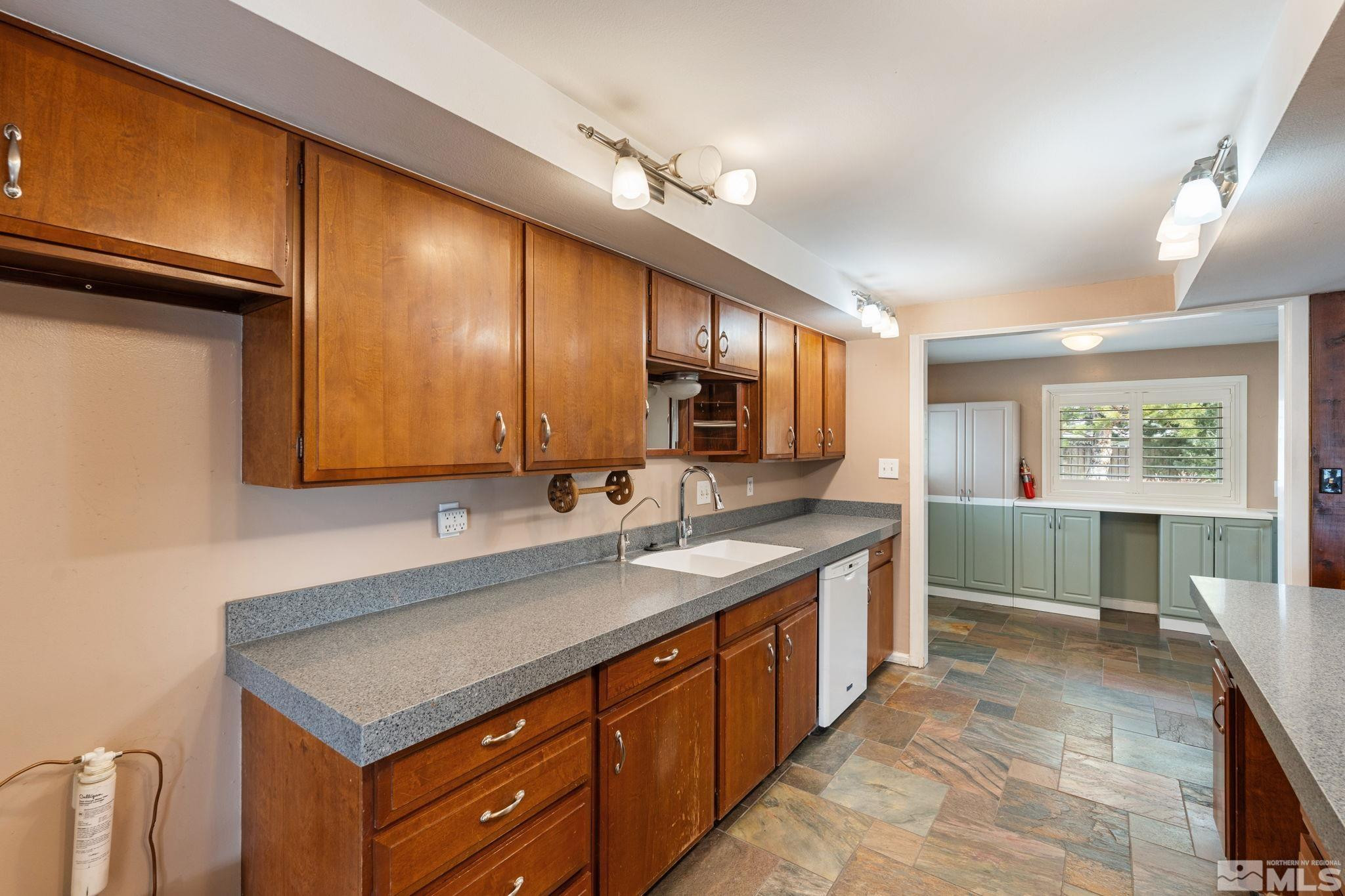 3325 Norman Drive Reno, NV 89509 - Photo 24 of 40 a kitchen with stainless steel appliances granite countertop a sink and cabinets