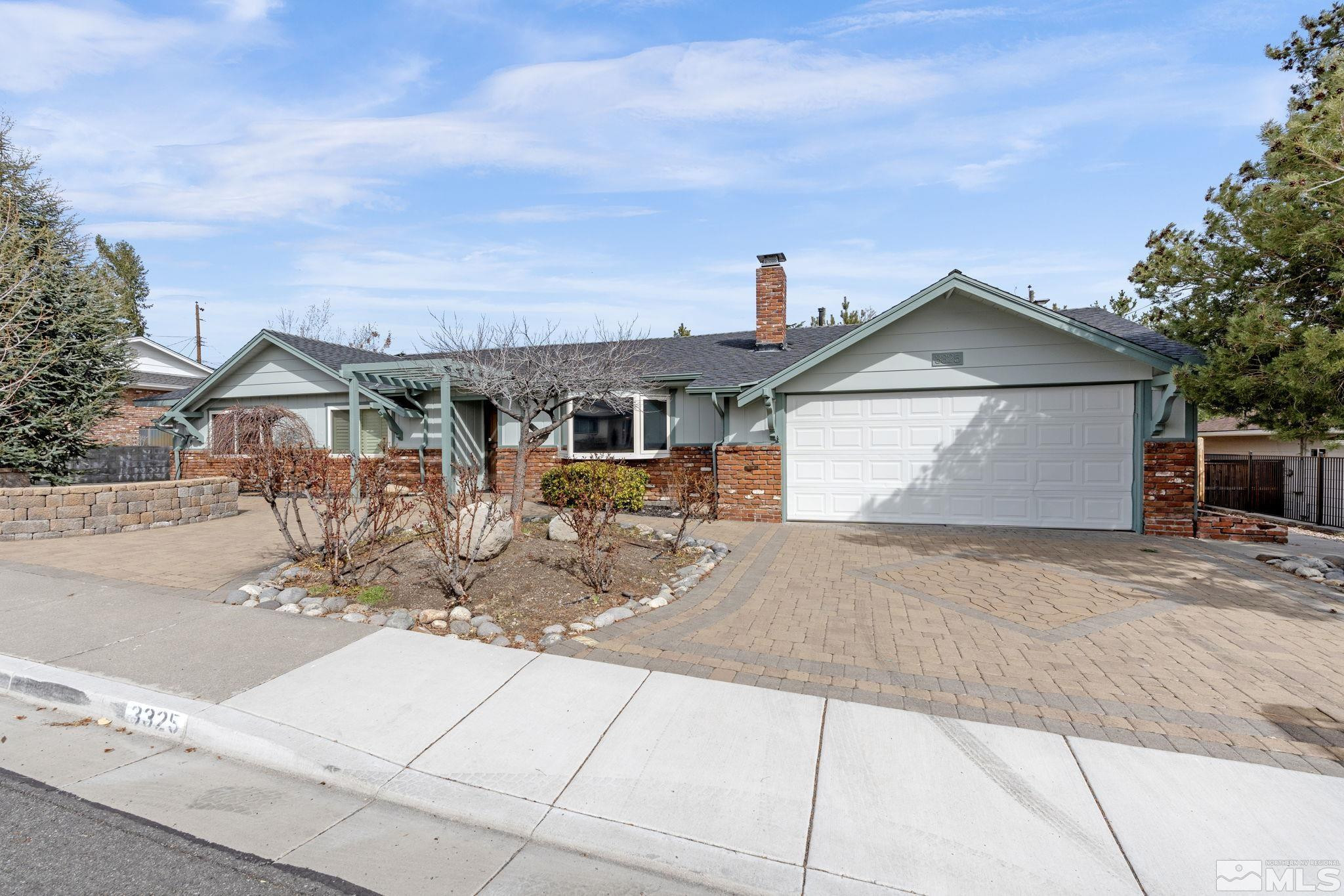 3325 Norman Drive Reno, NV 89509 - Photo 6 of 40 a front view of a house with a yard and garage