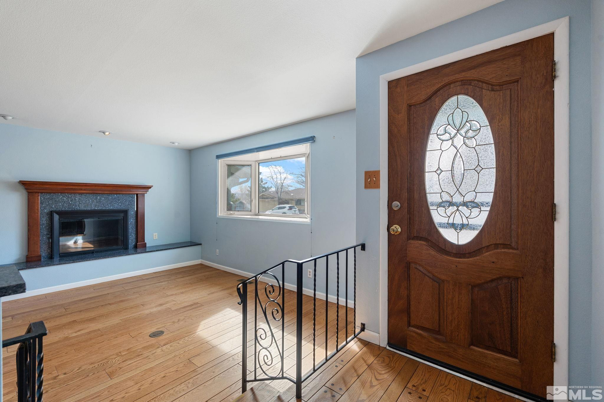 3325 Norman Drive Reno, NV 89509 - Photo 8 of 40 a view of an entryway with a grandfather clock and a wooden floor