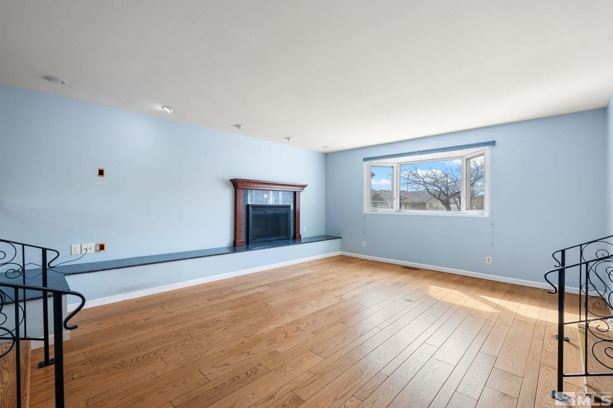 3325 Norman Drive Reno, NV 89509 - Photo 10 of 40 a view of an empty room with wooden floor and a window