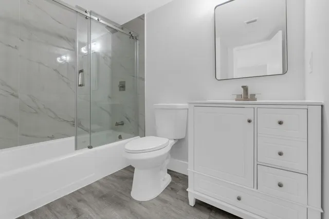 a bathroom with a toilet sink and shower