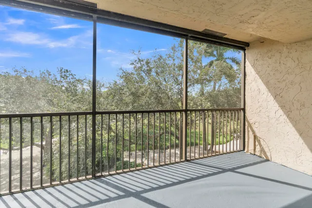 a view of a balcony with wooden floor