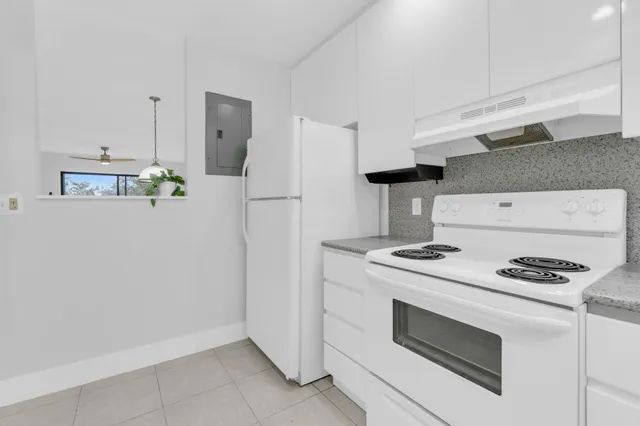 a kitchen with a stove and a refrigerator