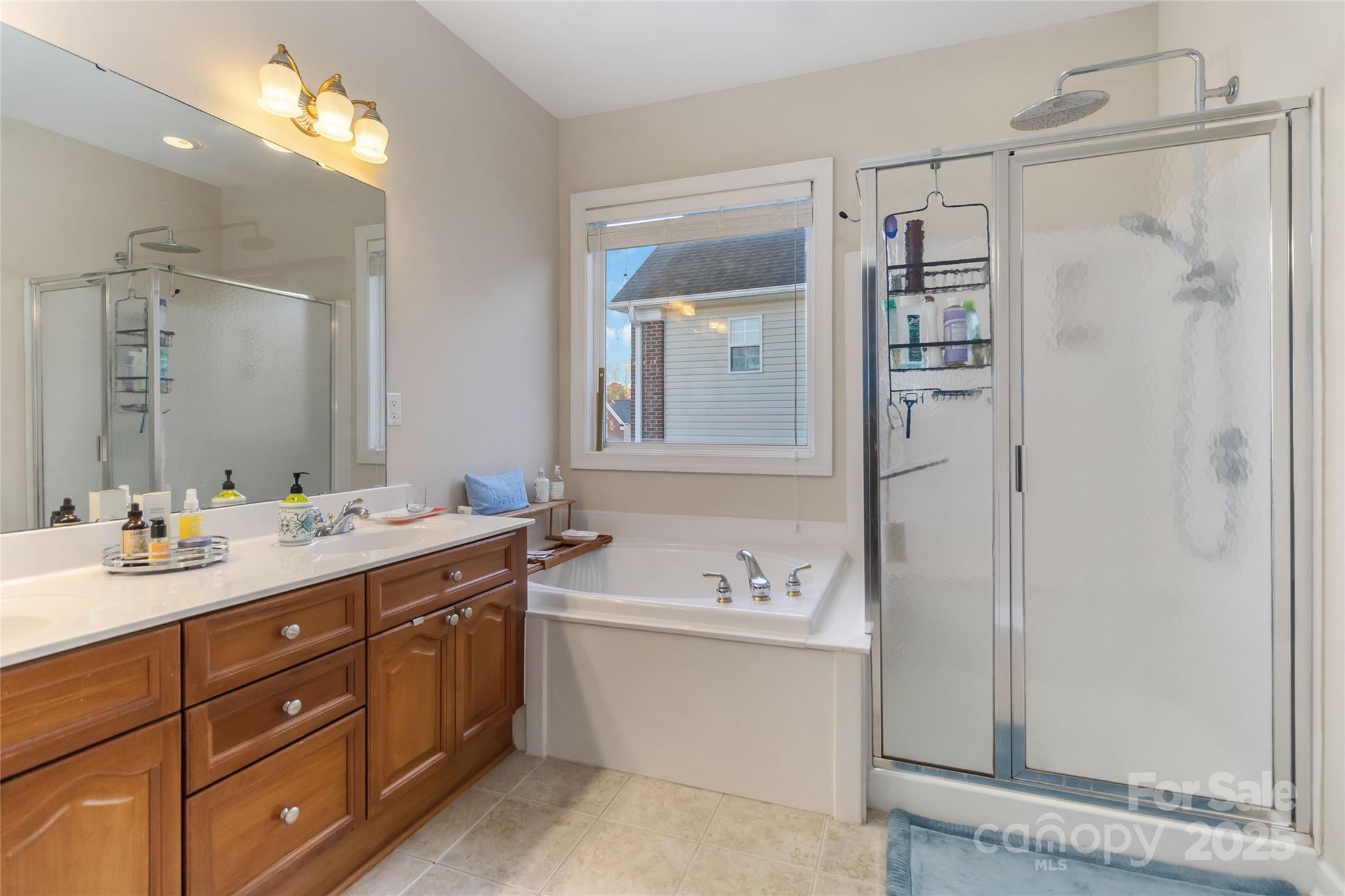 1608 Copperplate Road Charlotte, NC 28262 - Photo 22 of 31 a bathroom with a sink double vanity and shower