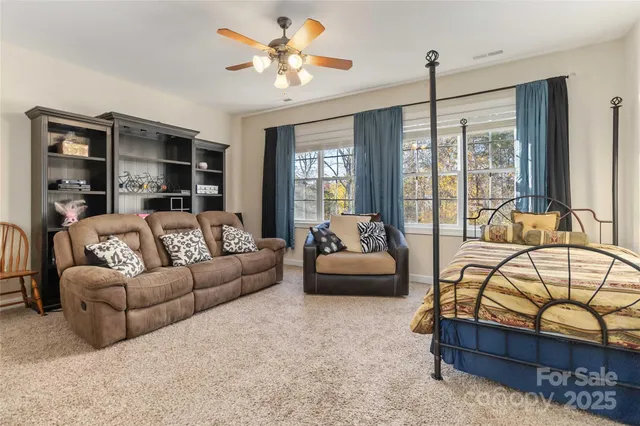 a view of workspace with lounge chair and windows