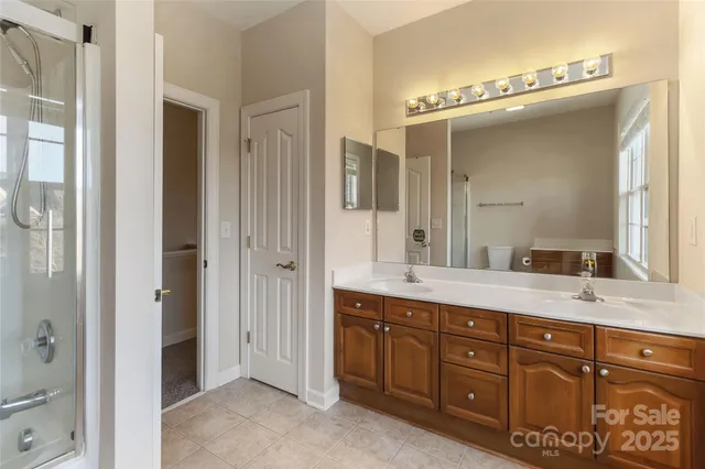 a bathroom with a granite countertop toilet and a shower