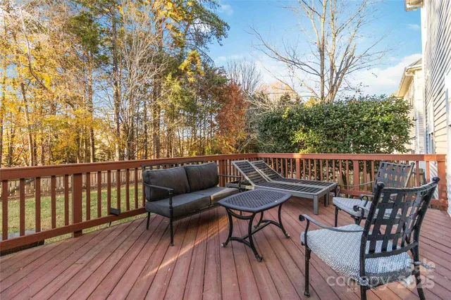 a view of balcony with wooden floor and outdoor seating