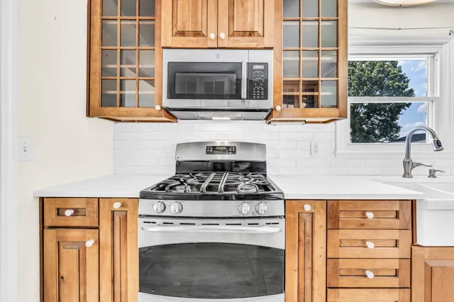 a kitchen with stainless steel appliances granite countertop a stove and a microwave