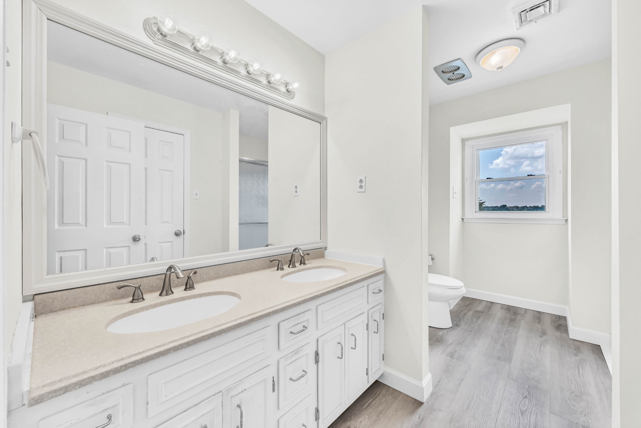 511 Snardon Mill Road Allensville, KY 42204 - Photo 25 of 44 a bathroom with a double vanity sink a toilet and a mirror