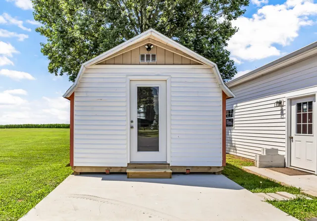 a small white house with a outdoor space