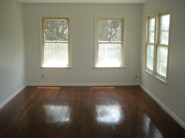 625 Everhart Road Corpus Christi, TX 78412 - Photo 3 of 8 a view of an empty room with wooden floor and a window
