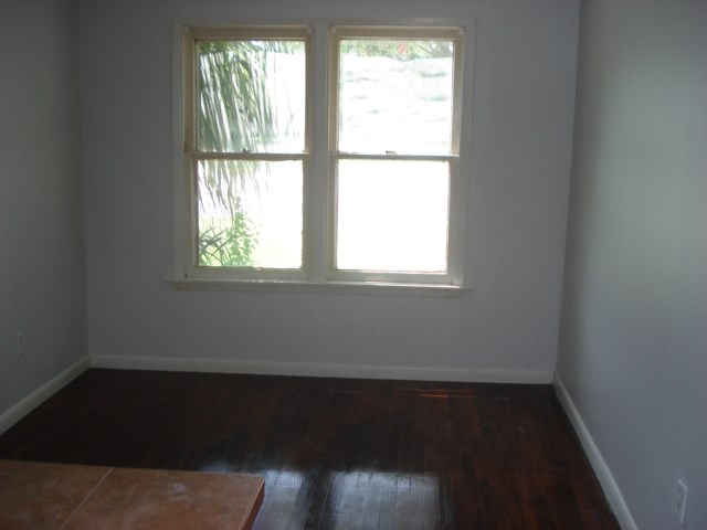 625 Everhart Road Corpus Christi, TX 78412 - Photo 4 of 8 a view of an empty room with wooden floor and a window