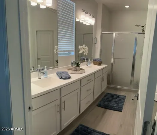 a bathroom with a sink double vanity and a mirror