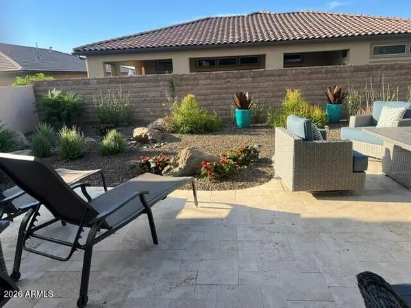 a view of a house with backyard and sitting area