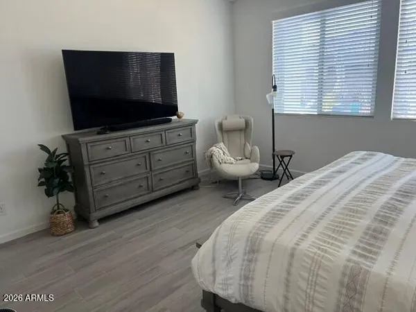 a bedroom with a bed and flat screen tv