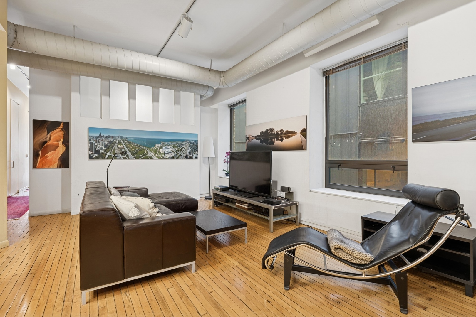 957 West Huron Street, Unit 2 Chicago, IL 60642 - Photo 13 of 26 a living room with furniture gym equipment and a large window