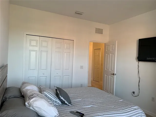 a bedroom with a bed and a night stand