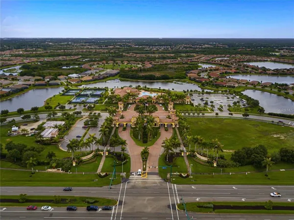 an aerial view of residential houses with outdoor space and swimming pool