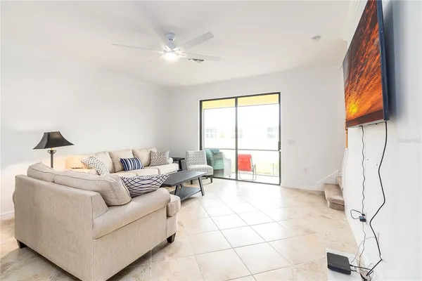 a living room with furniture and a floor to ceiling window