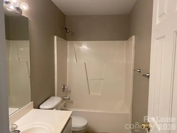 a white toilet sitting next to a bathroom sink